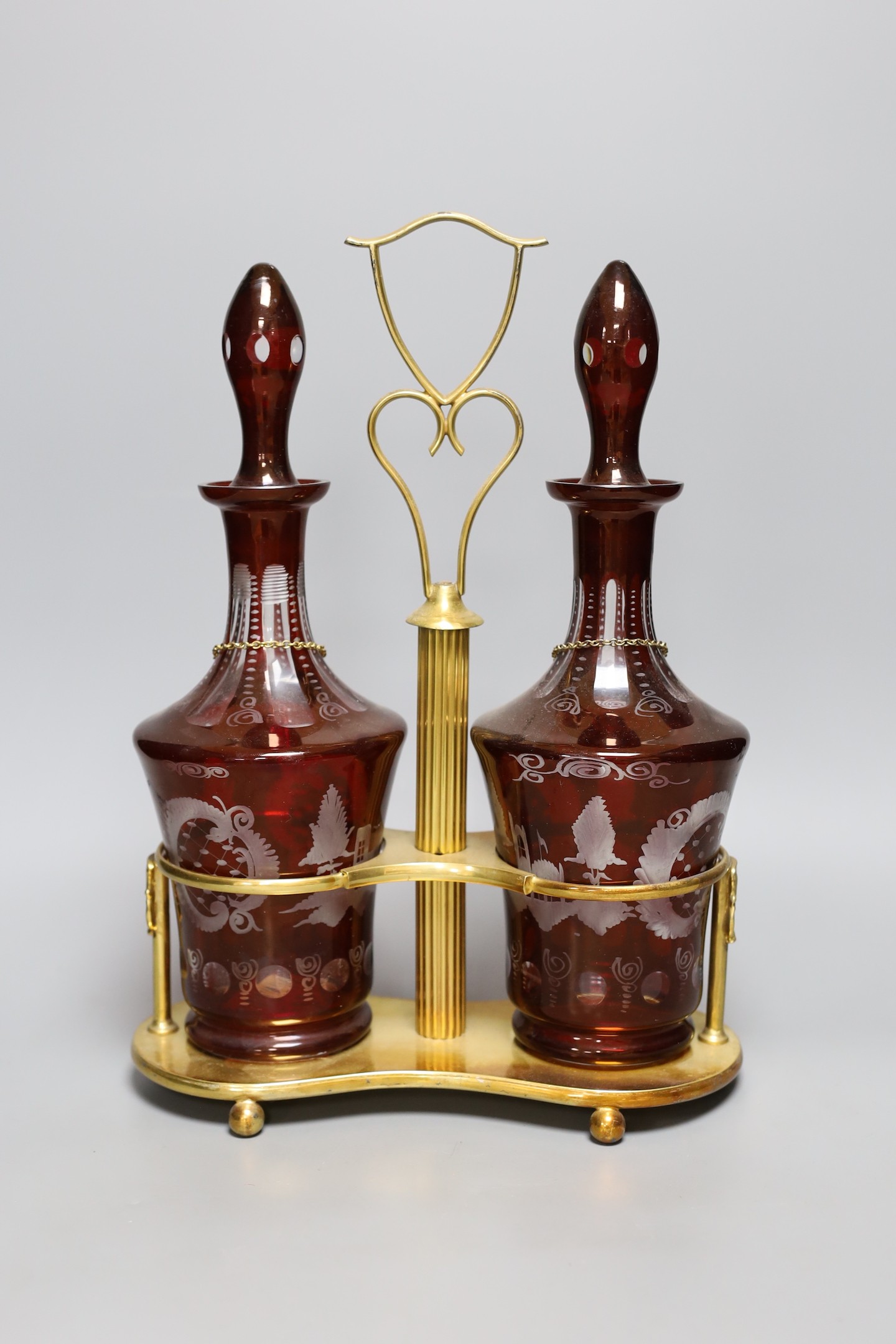 A pair of Bohemian cut glass decanters on gilt metal stand with ‘WHISKY’ and ‘SHERRY’ labels, 38cm total